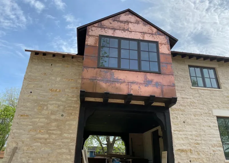 Copper metal panel facade on a stone building for Skylight Installation in Spring Lake Park