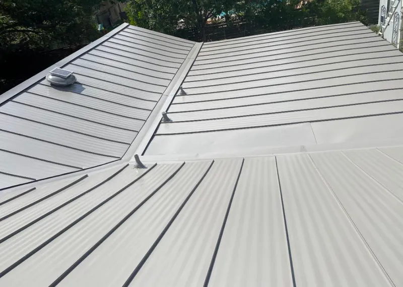 Solar attic fan installed on a metal roof for Roof Ventilation in Spring Lake Park
